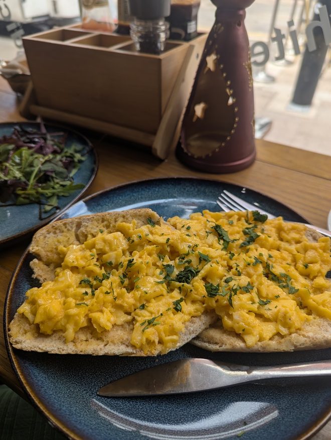 Scrambled eggs with herbs on flatbread.