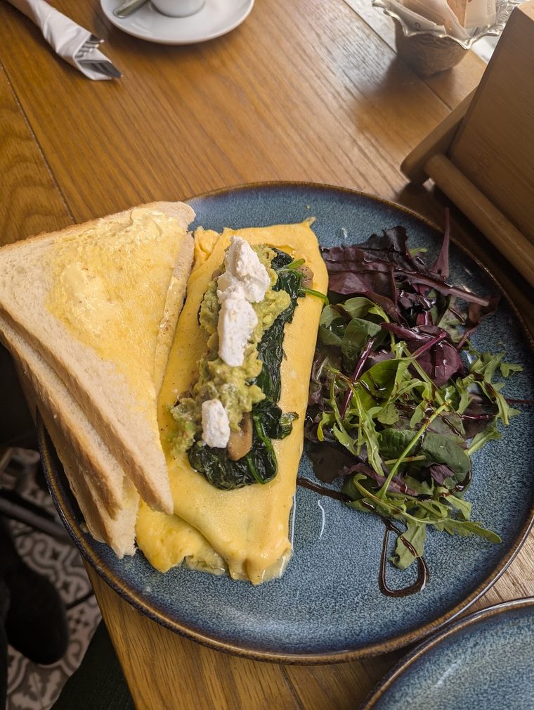 A spinach and feta omelette with salad leaves and toast.